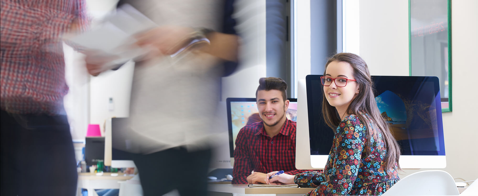 accounting-casper-college Young adults in a busy office or co-work space.